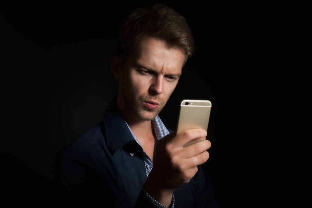 Man reading critique on phone